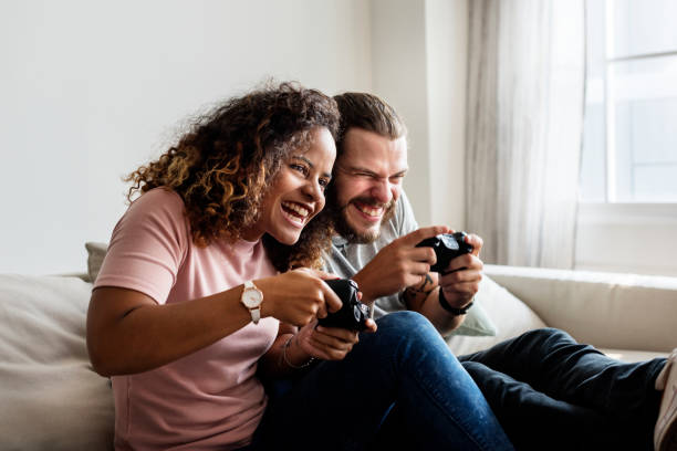 istock Couple playing game at home together 951393128