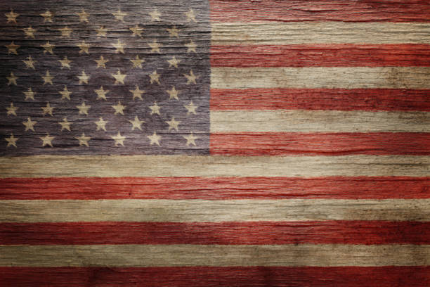 Close up view of American flag with stars and stripes. The stripes of this flag have been sewn together and the stars were embroidered. This flag was used to honor a military serviceman at his funeral.