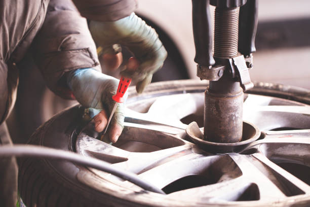 istock Replacing car wheel and tyre 951402124