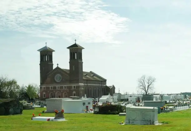 Photo of St. John the Baptist Roman Catholic Church with the graveyard next to it