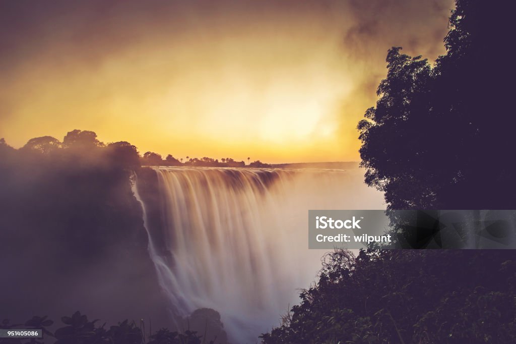 Victoria Falls Sunrise Long Exposure The Victoria Falls in flood at sunrise in April 2018 Victoria Falls Zimbabwe Africa Waterfall Stock Photo