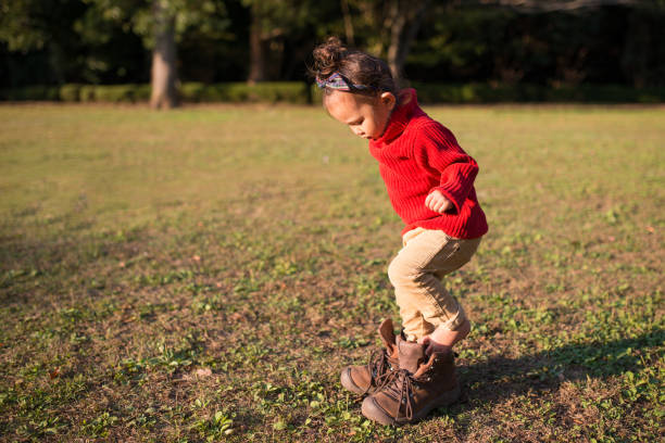 Little Girl Wearing Boots That Are Too 