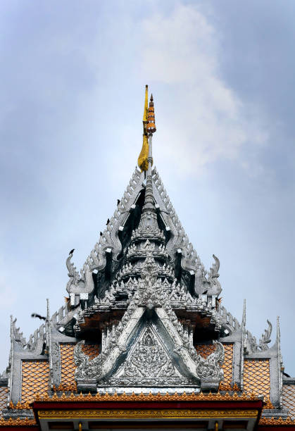 istock thai temple,thai art style triangle roof with grey sky in raining day 951413546