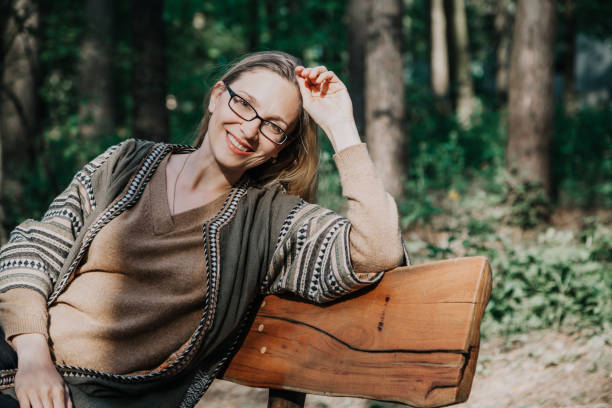 istock Slim blonde is sitting on wooden bench 951416616