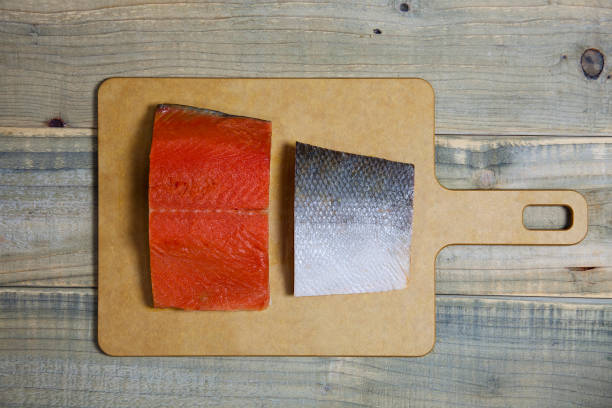 Fresh salmon raw fillet ready to cook. Top view of ingredients on wooden cutting board January, 08, 2015: Cooking, Fresh Ingredient, Preparing Food Image sockeye salmon filet stock pictures, royalty-free photos & images