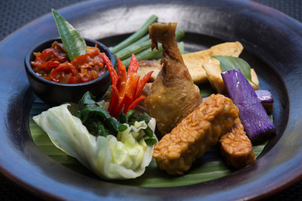 istock Baked roasted fried chicken drumstick with vegetables and hot sauce 951427584