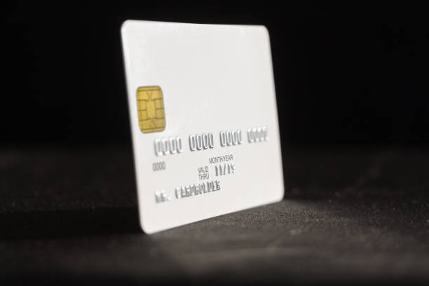 istock Credit card on dark background, side view 951427832