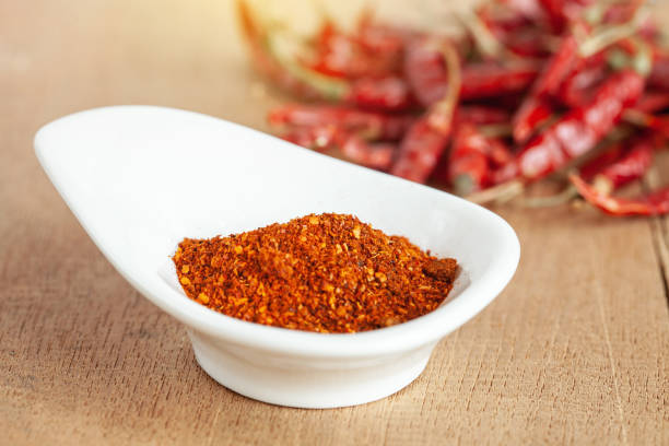 istock Cayenne pepper in white dish and dried chilli on wood table. 951430674