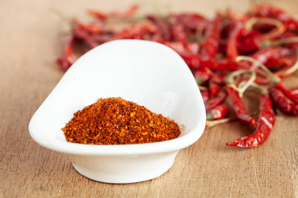 istock Cayenne pepper in white dish and dried chilli on wood table. 951430684