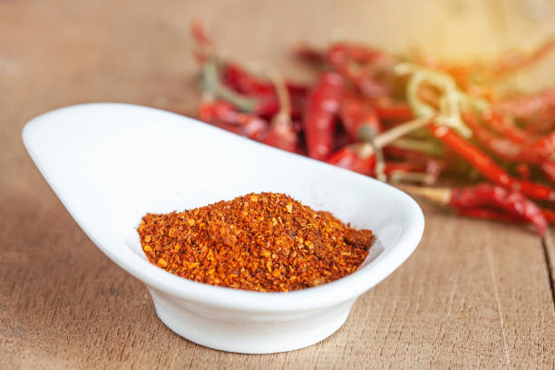 istock Cayenne pepper in white dish and dried chilli on wood table. 951430686