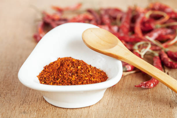 istock Cayenne pepper in white dish and dried chilli on wood table. 951430694