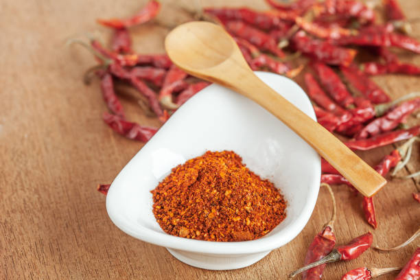 istock Cayenne pepper in white dish and dried chilli on wood table. 951430718
