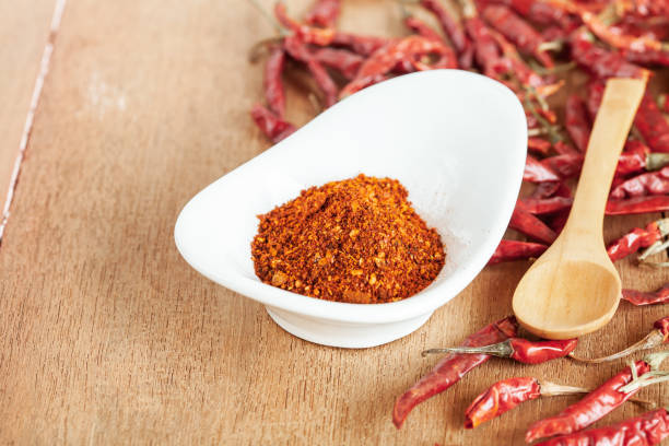 istock Cayenne pepper in white dish and dried chilli on wood table. 951430720