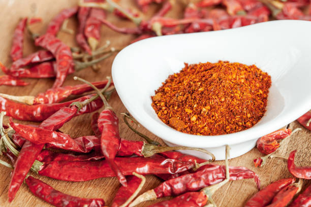 istock Cayenne pepper in white dish and dried chilli on wood table. 951430730