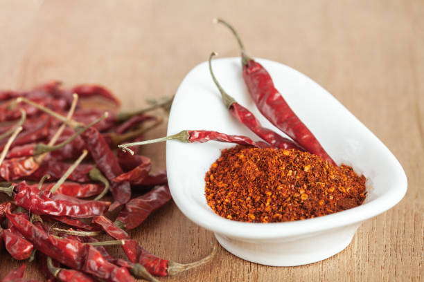 istock Cayenne pepper in white dish and dried chilli on wood table. 951430758
