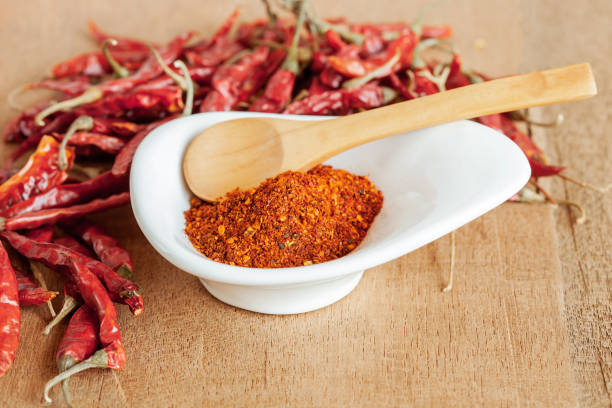 istock Cayenne pepper in white dish and dried chilli on wood table. 951430760
