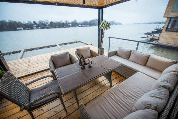 istock Rest place wit hsofas on balcony of cottage near river 951435758