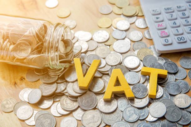 istock Vat Concept.Word vat put on coins and calculator on table. 951436332