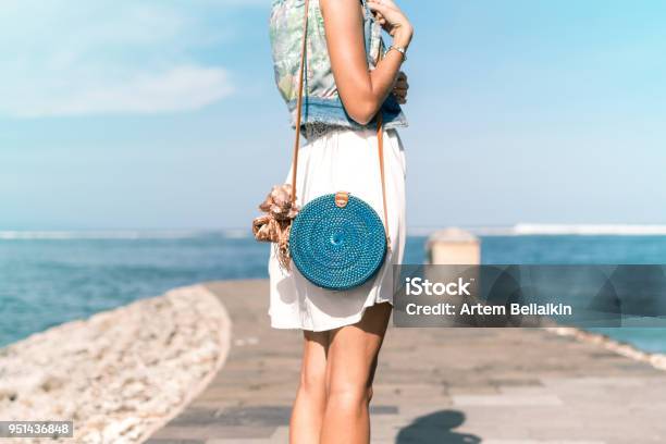 Woman With Fashionable Stylish Blue Rattan Bag And Silk Scarf Outside Tropical Island Of Bali Indonesia Rattan Handbag And Silk Scarf Stock Photo - Download Image Now