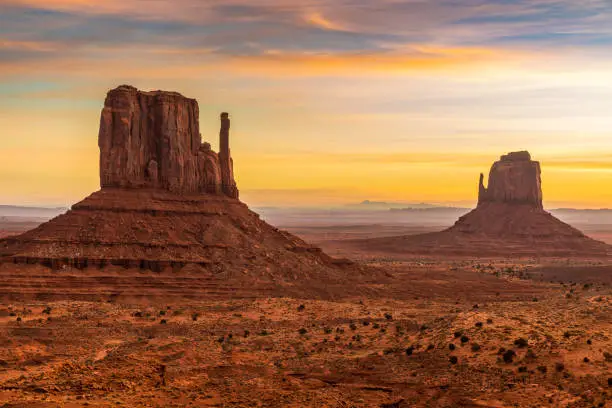 Stunning orange sunrise in this stock photo of Monument Valley--The Mittens.