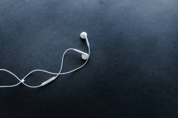 istock little white headphones on a blue background 951443866