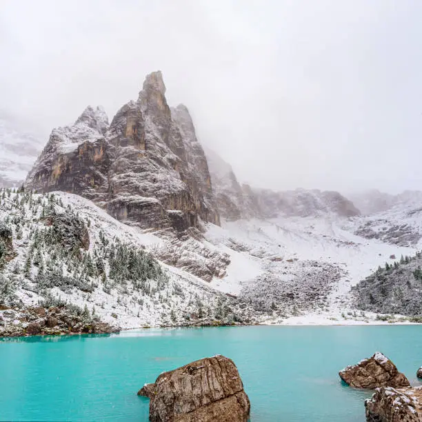 Amazing view of Sorapis lake in Dolomite Alps, Italy, with unusual color of water.