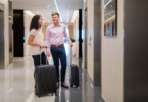 istock Couple talking while holding luggage in corridor 951447836