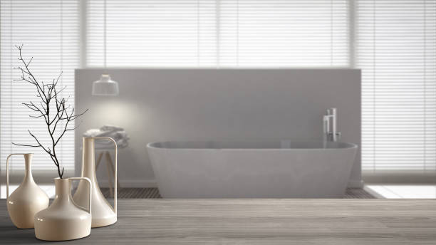 istock Wooden table top or shelf with minimalistic modern vases over blurred scandinavian clean bathroom, white interior design 951455952