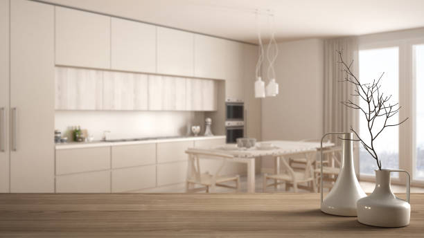 istock Wooden table top or shelf with minimalistic modern vases over blurred minimalist classic kitchen, white interior design 951456192