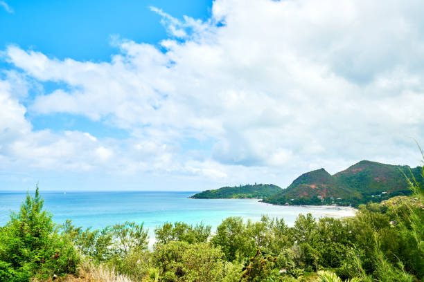 Gentle waves touching white sandy beach of tropical island nobody till horizon on sunny day