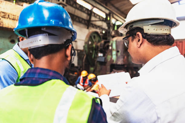 istock Factory owner showing his ideas towards his engineers 951466974