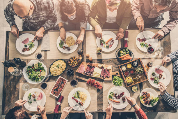 istock Group of people having meal together 951470748