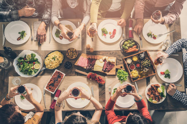 istock Group of people having meal together 951471050