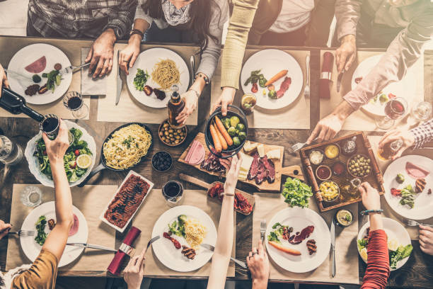 istock Group of people having meal together 951471318