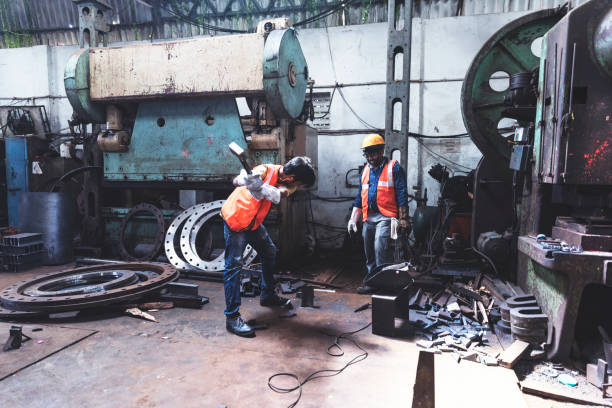istock Hammering apart two metal pieces. 951471400