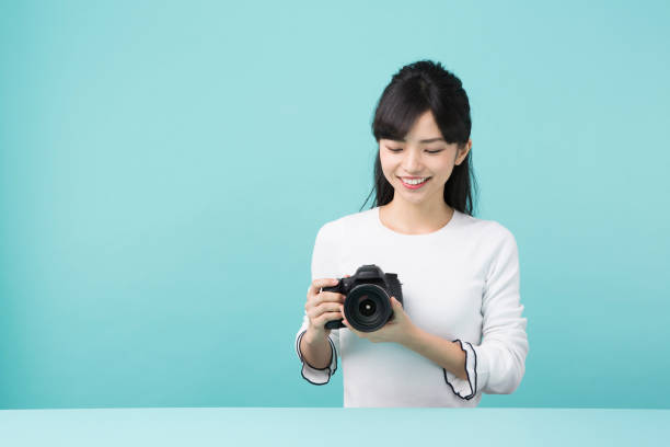 istock A woman holding a camera 951471530