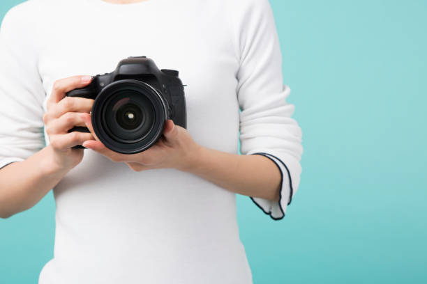 istock A woman holding a camera 951471944