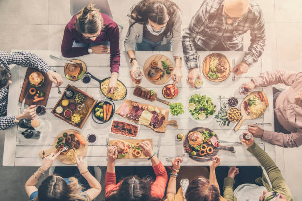 istock Group of people having meal together 951474264