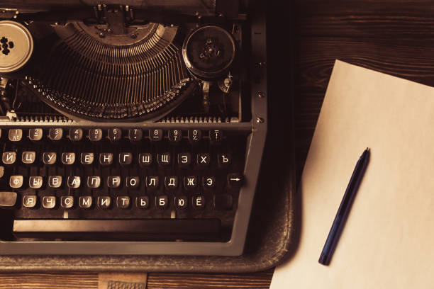 istock typewriter and a white sheet and ballpoint pen. Retro style 951474456