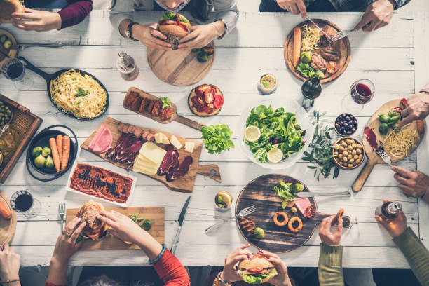 istock Group of people having meal together 951474644
