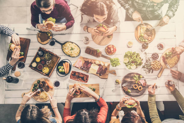 istock Group of people having meal together 951474676