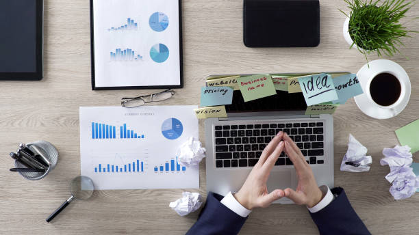 istock Businessman in suit thinking about company development at workplace, top view 951480840