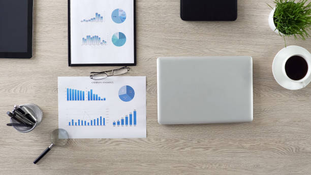 istock Beginning of workday, empty workplace of businessman with graphs and laptop 951480960