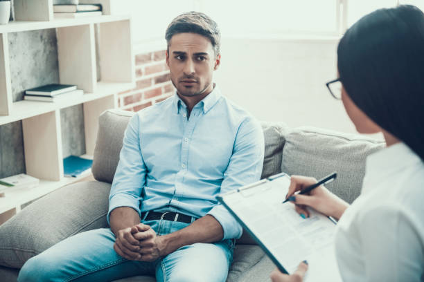 istock Young upset man at psychologist reception. 951480990