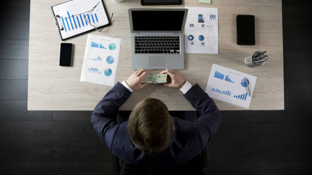 istock Happy businessman holding stack of money, reward for successful project 951481078