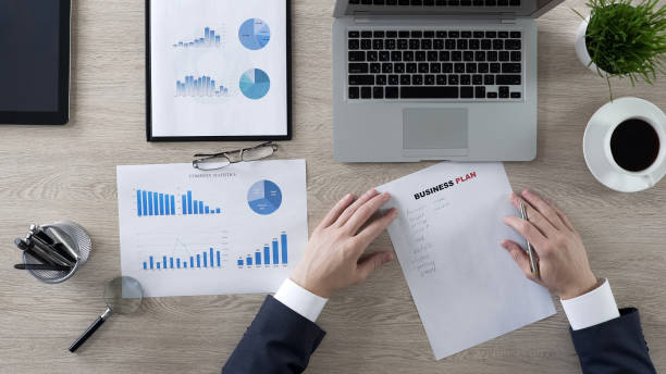 istock General manager pondering about ideas on business plan, crisis at work, top view 951481136