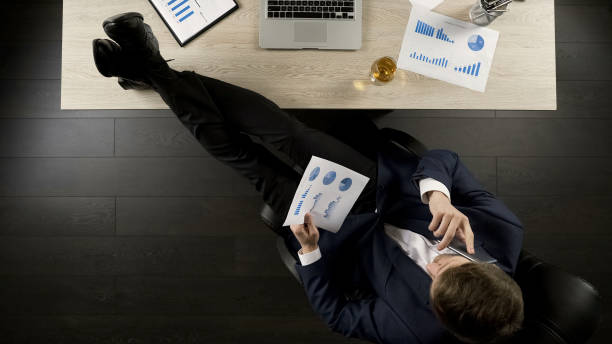 istock Successful investor viewing project report, discussing over phone details 951481212