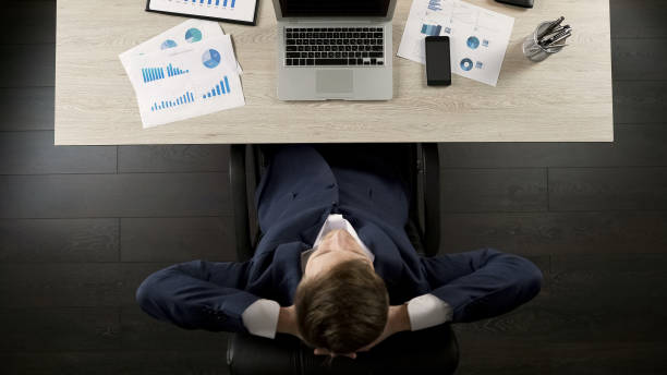 istock Man sitting back in office chair relaxed and satisfied with business project 951481228