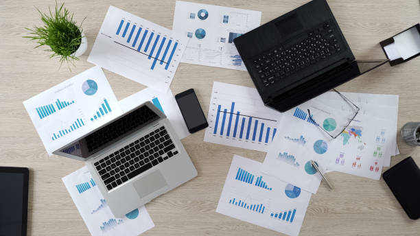 istock Two corporate laptops in big office, work on business project, top view 951481316