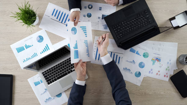 istock Company employees discussing statistics together, sharing opinions, top view 951481372